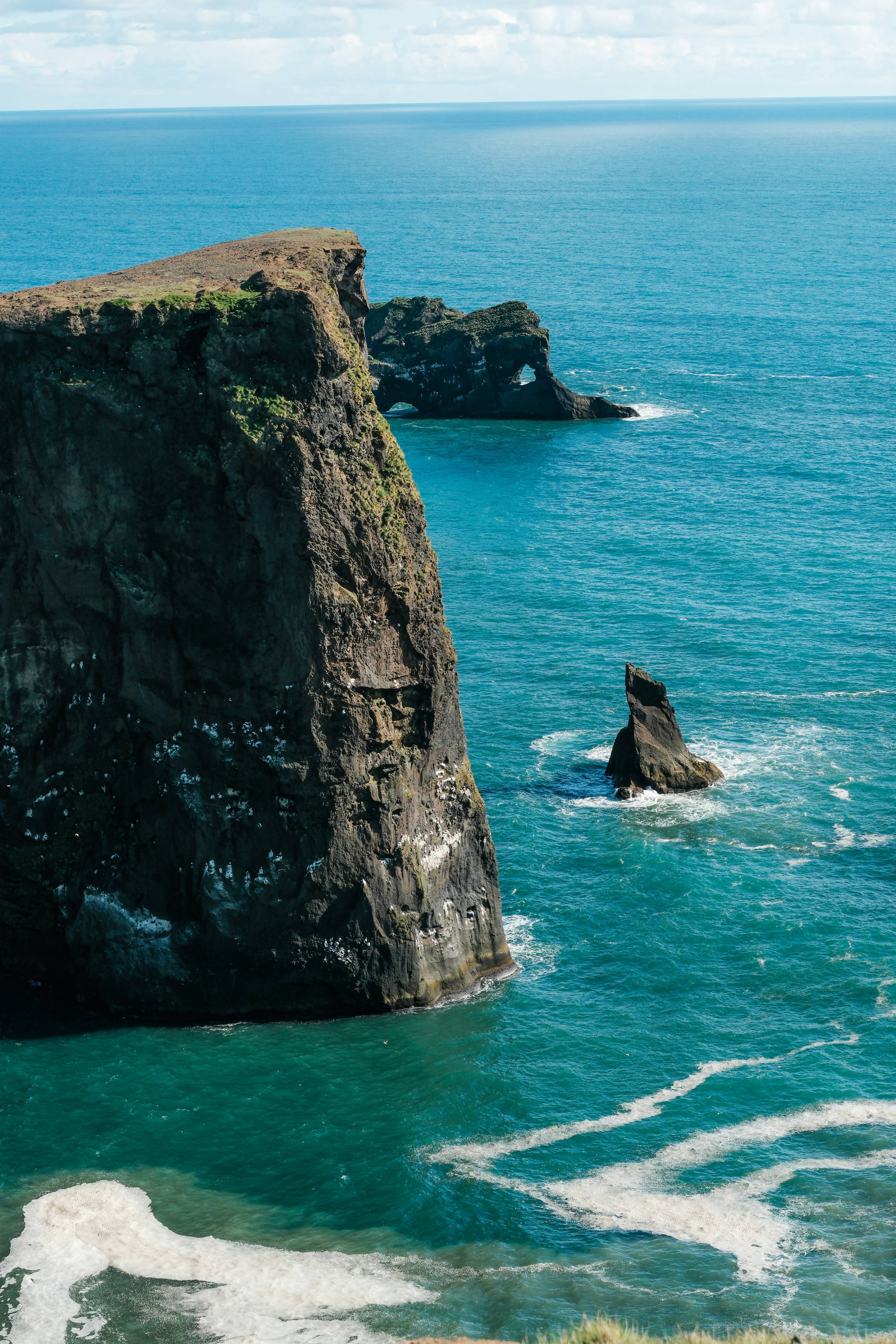 Ocean cliffs rise majestically against the sea.