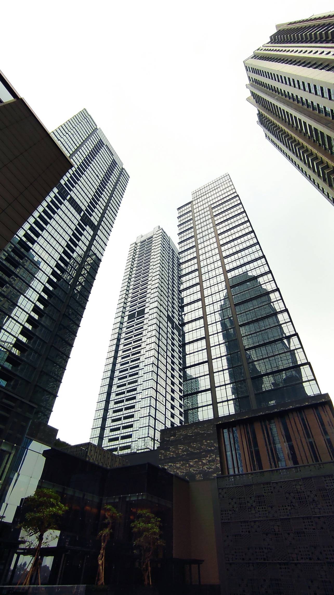 a couple of tall buildings sitting next to each other