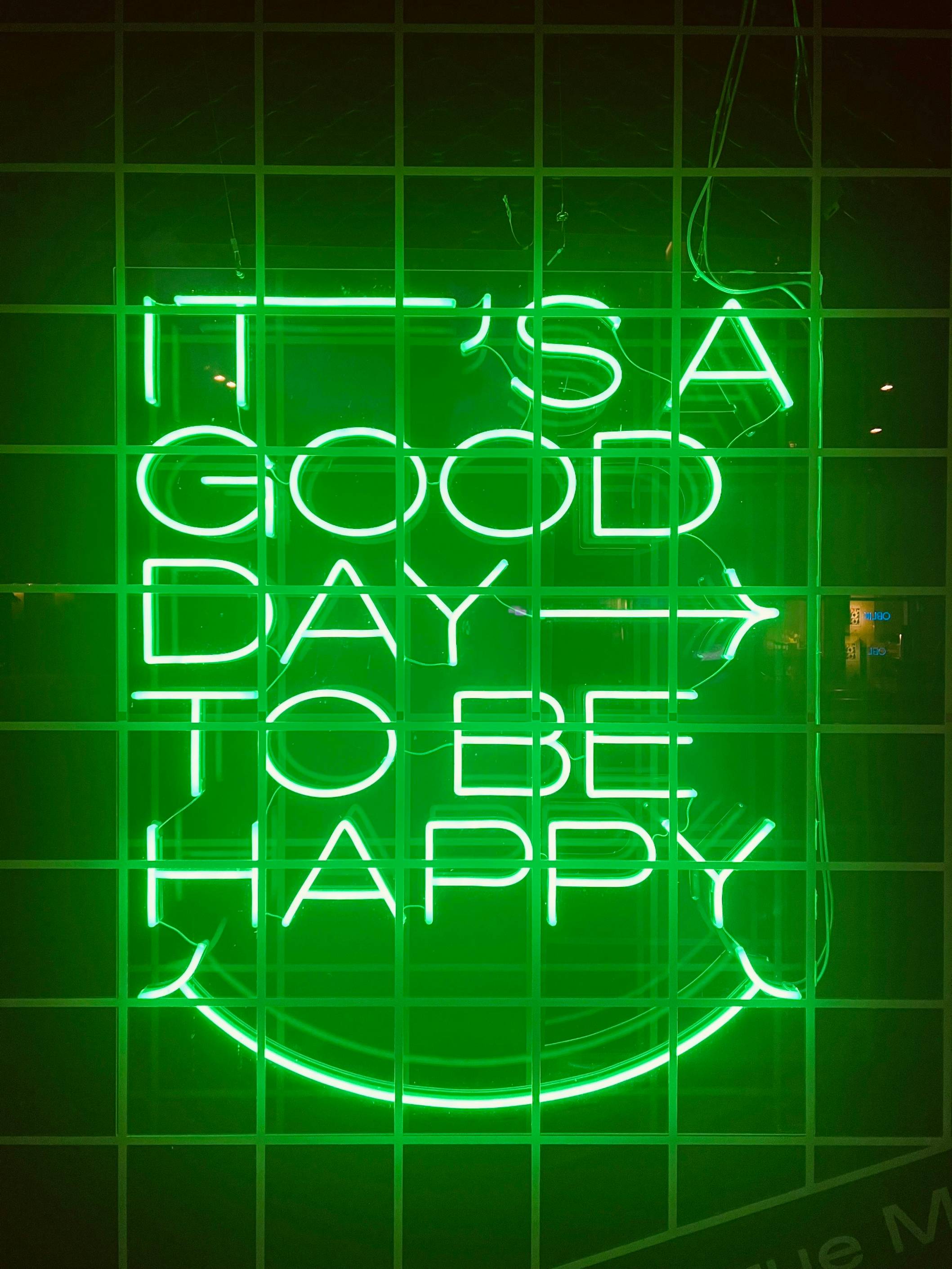 a neon sign that says it's a good day to be happy