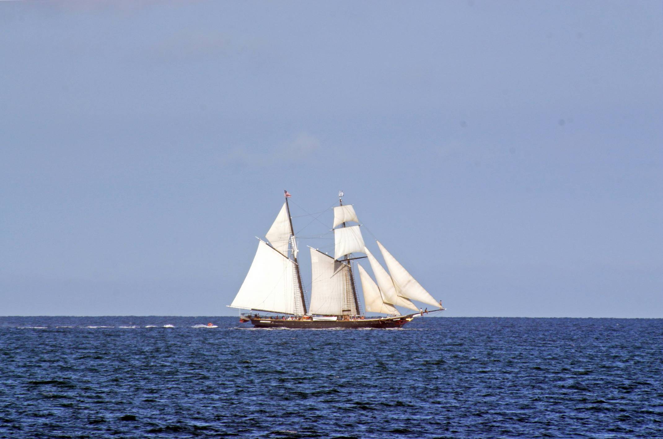 white sail boat on sea during daytime