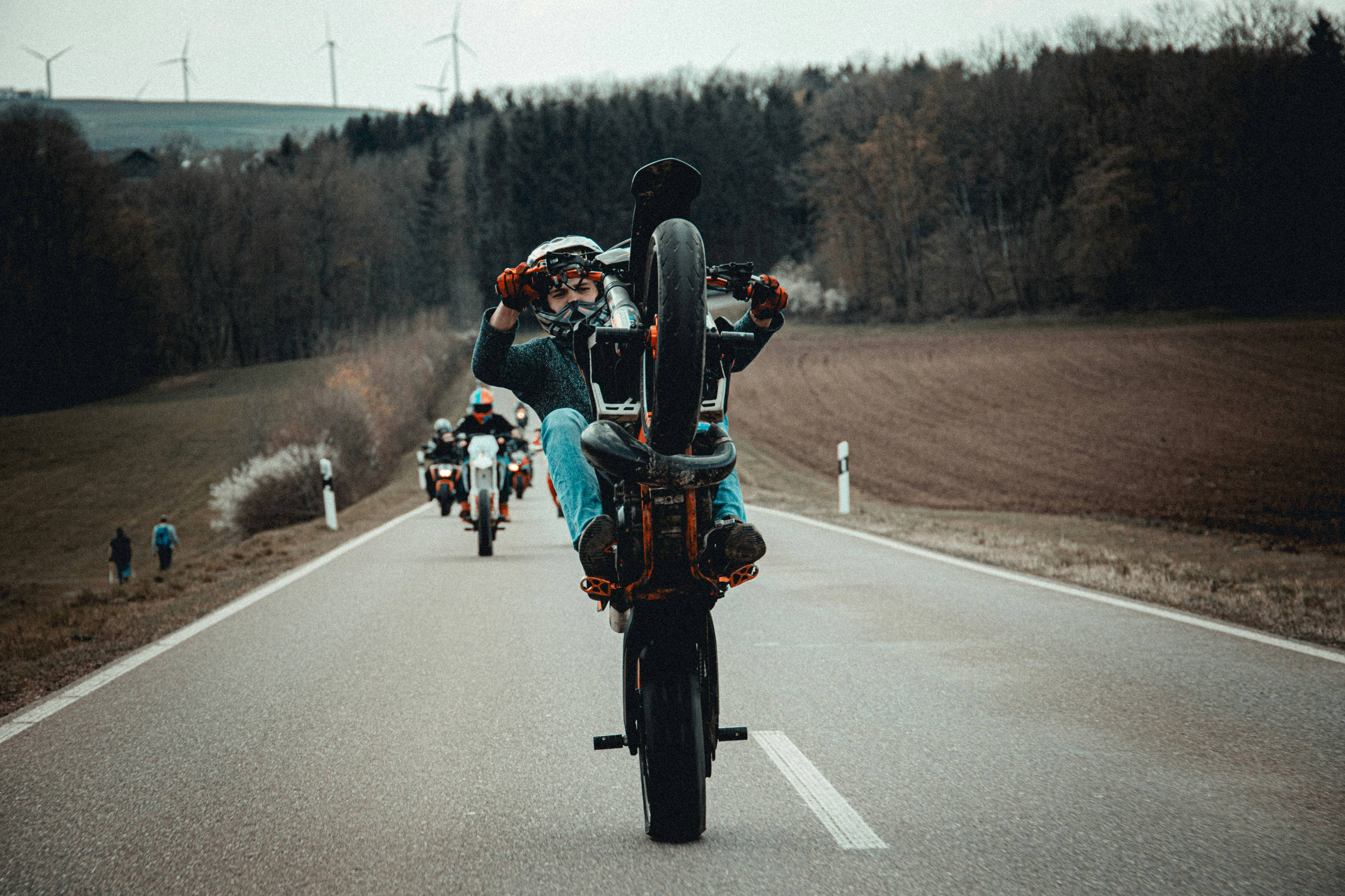 man in black jacket riding motorcycle on road during daytime