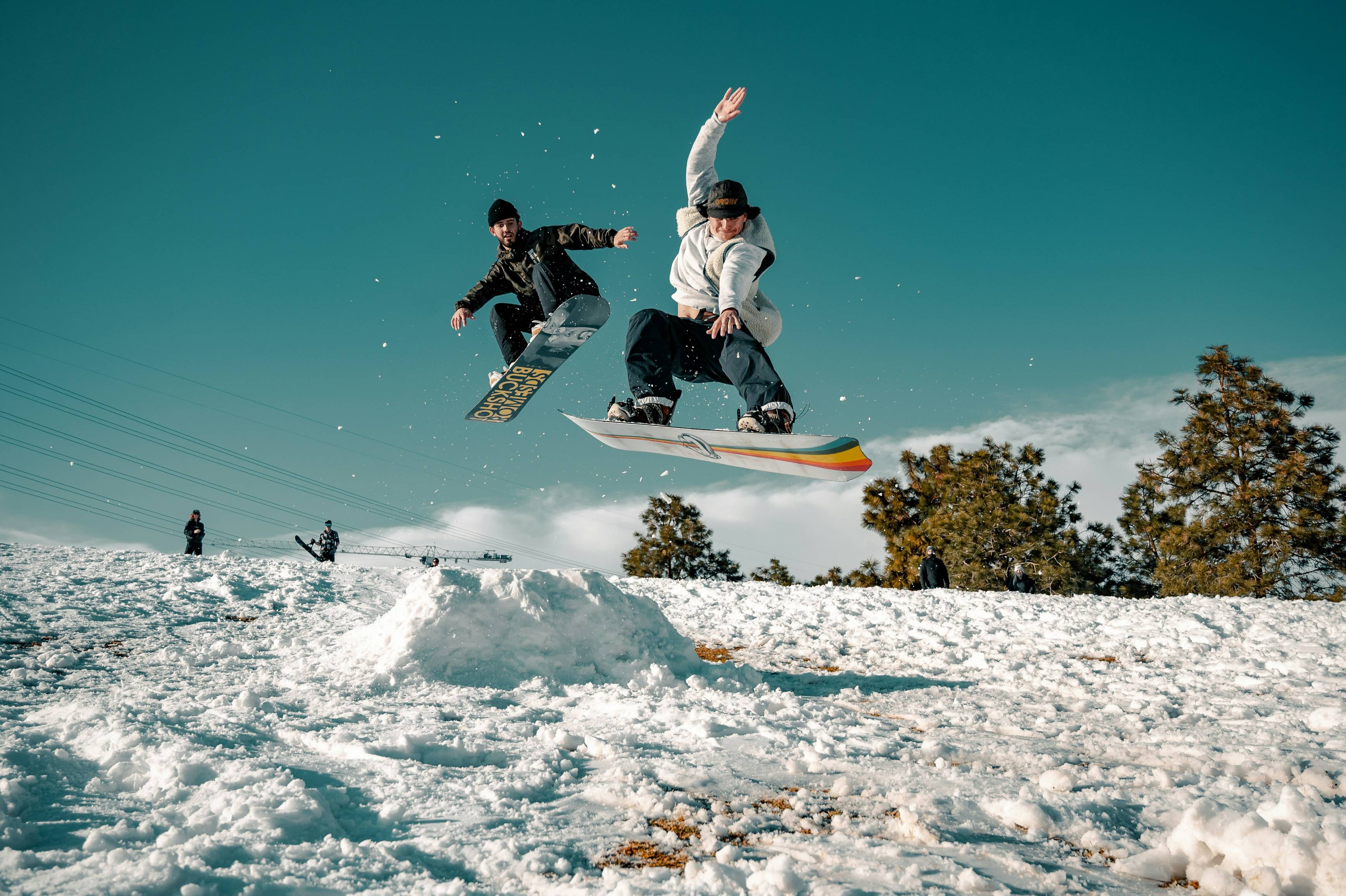 man in black and white jacket riding on snowboard during daytime